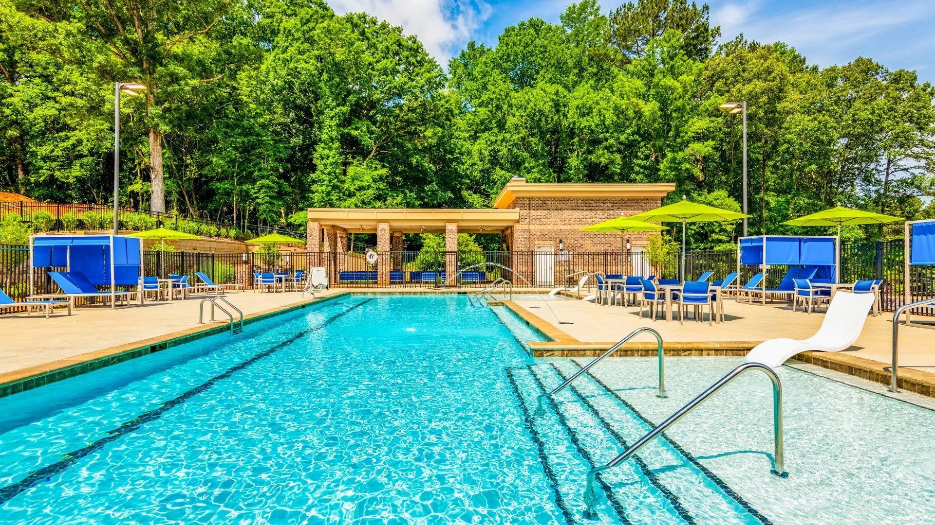 Vibrant pool area with lounge chairs and shaded seating