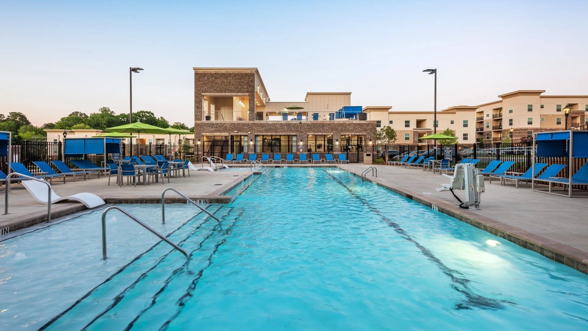 Swimming pool area with lounge chairs and cabanas