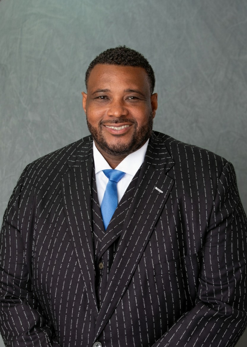 A man in a suit and tie is smiling for the camera.