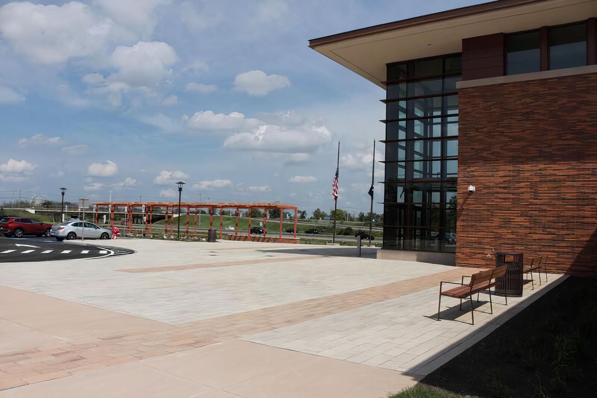 A large brick building with a parking lot in front of it.