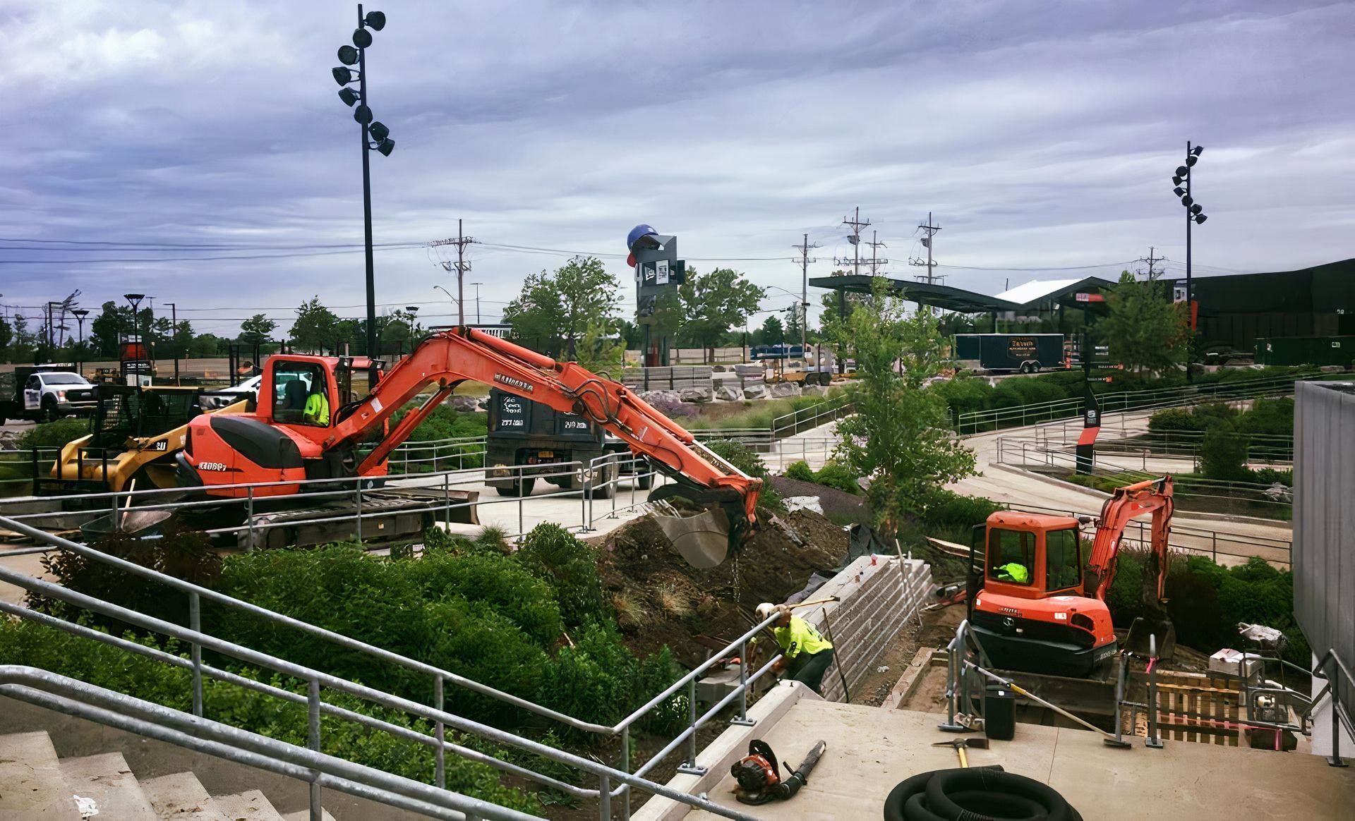 A group of construction vehicles are working on a construction site.