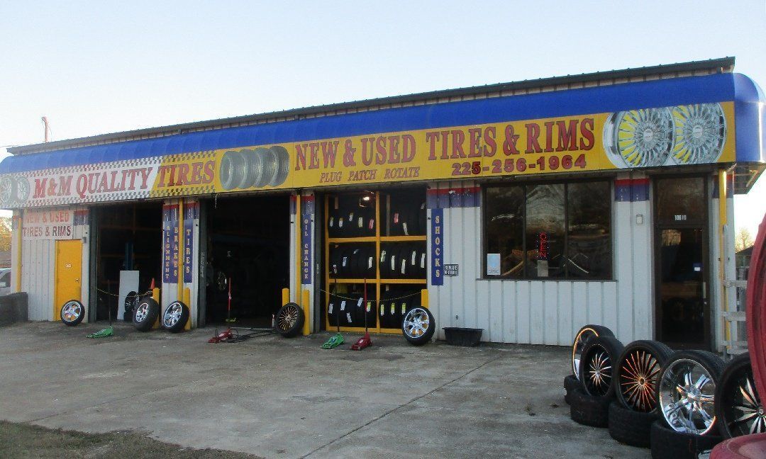 A tire shop with blue and yellow signage reading