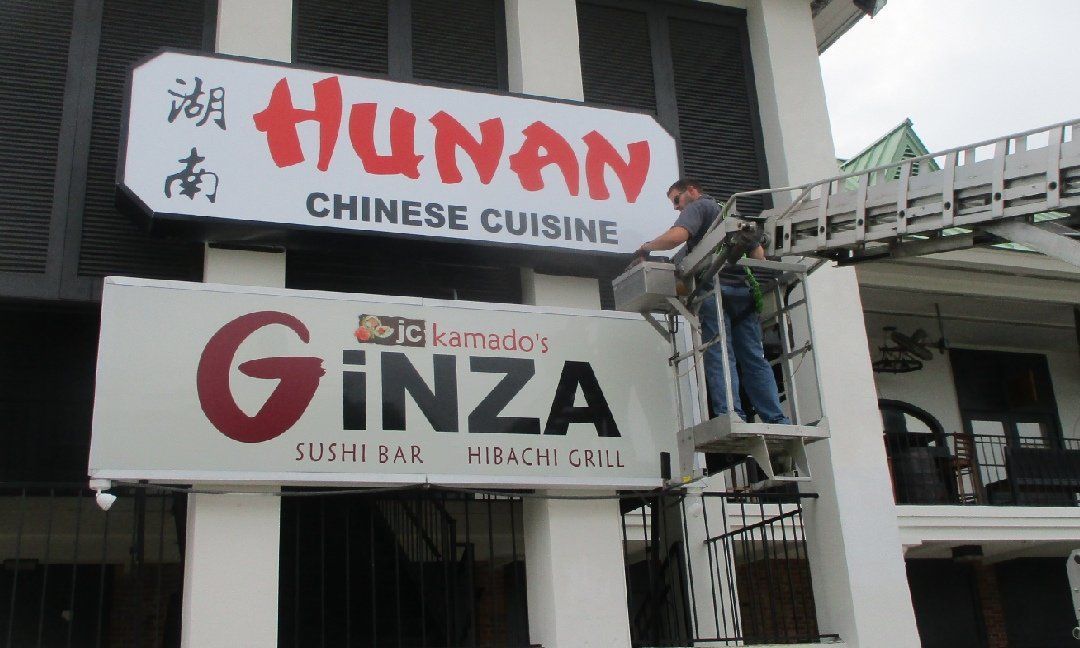 Bus stop with a large advertisement featuring a man promoting a 