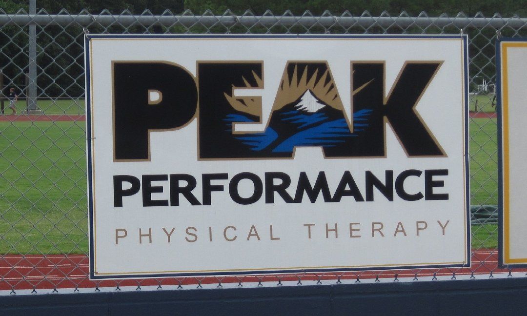 Sign for Peak Performance Physical Therapy with a mountain logo and text.