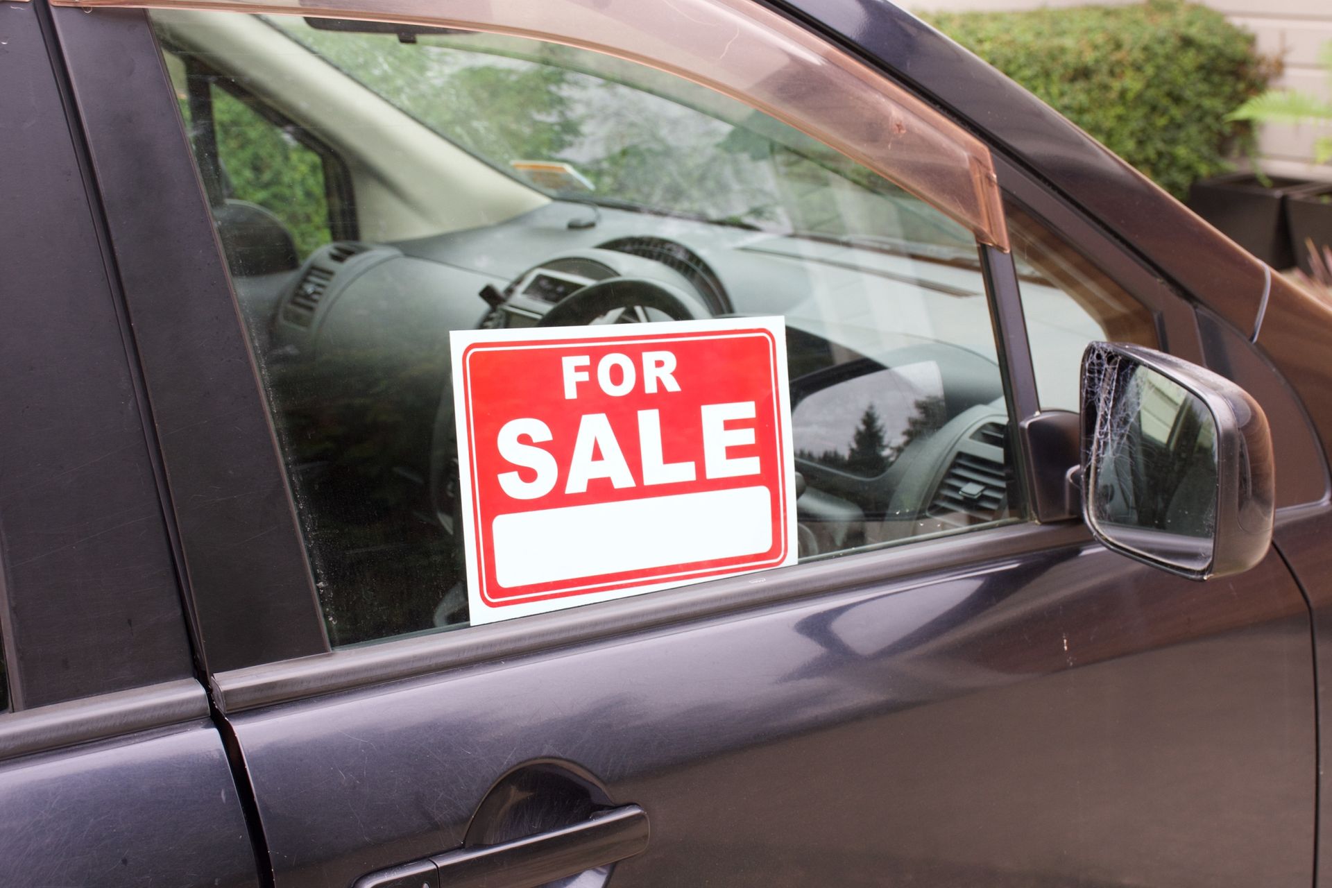 A dark-colored car with a 