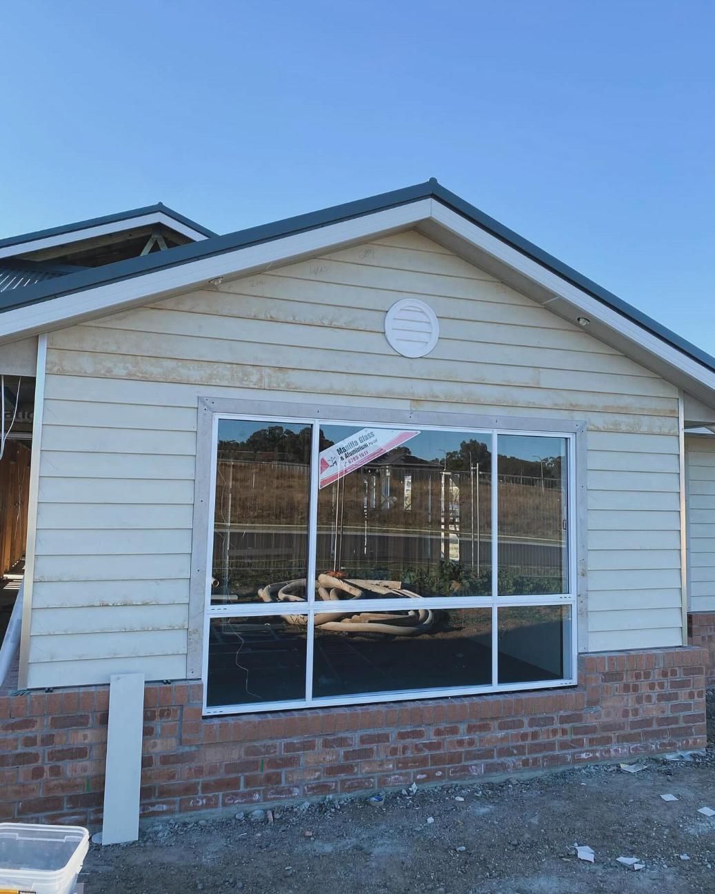 A House With a Lot of Windows and a Clock on the Roof  — Trussted Frames & Trusses In Taminda, NSW
