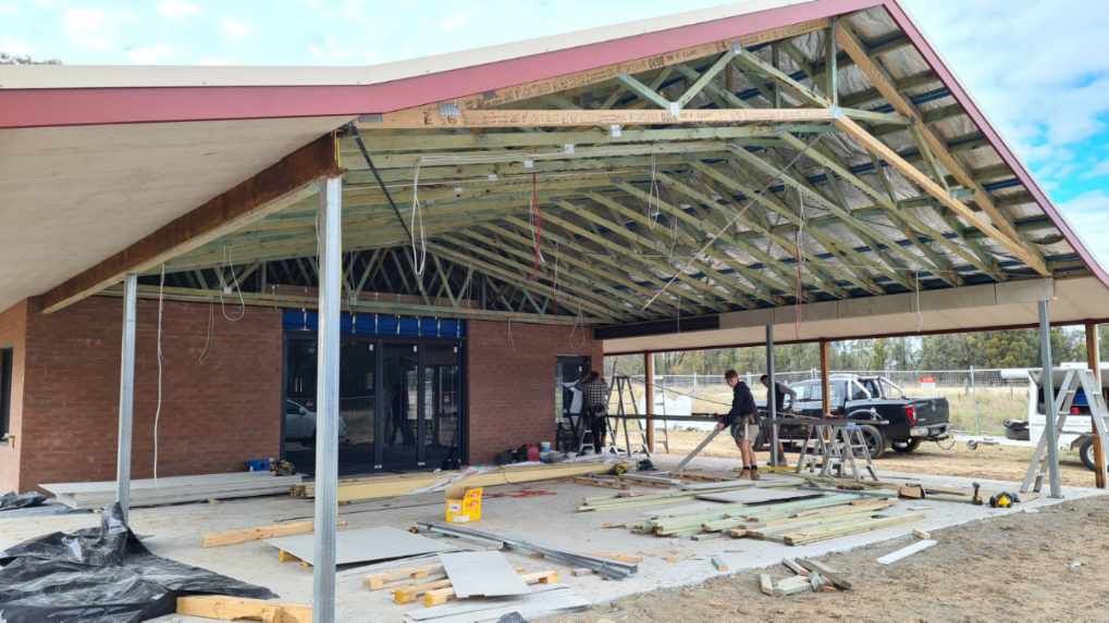 The inside of a building under construction with a skylight in the middle — Trussted Frames & Trusses In Taminda, NSW