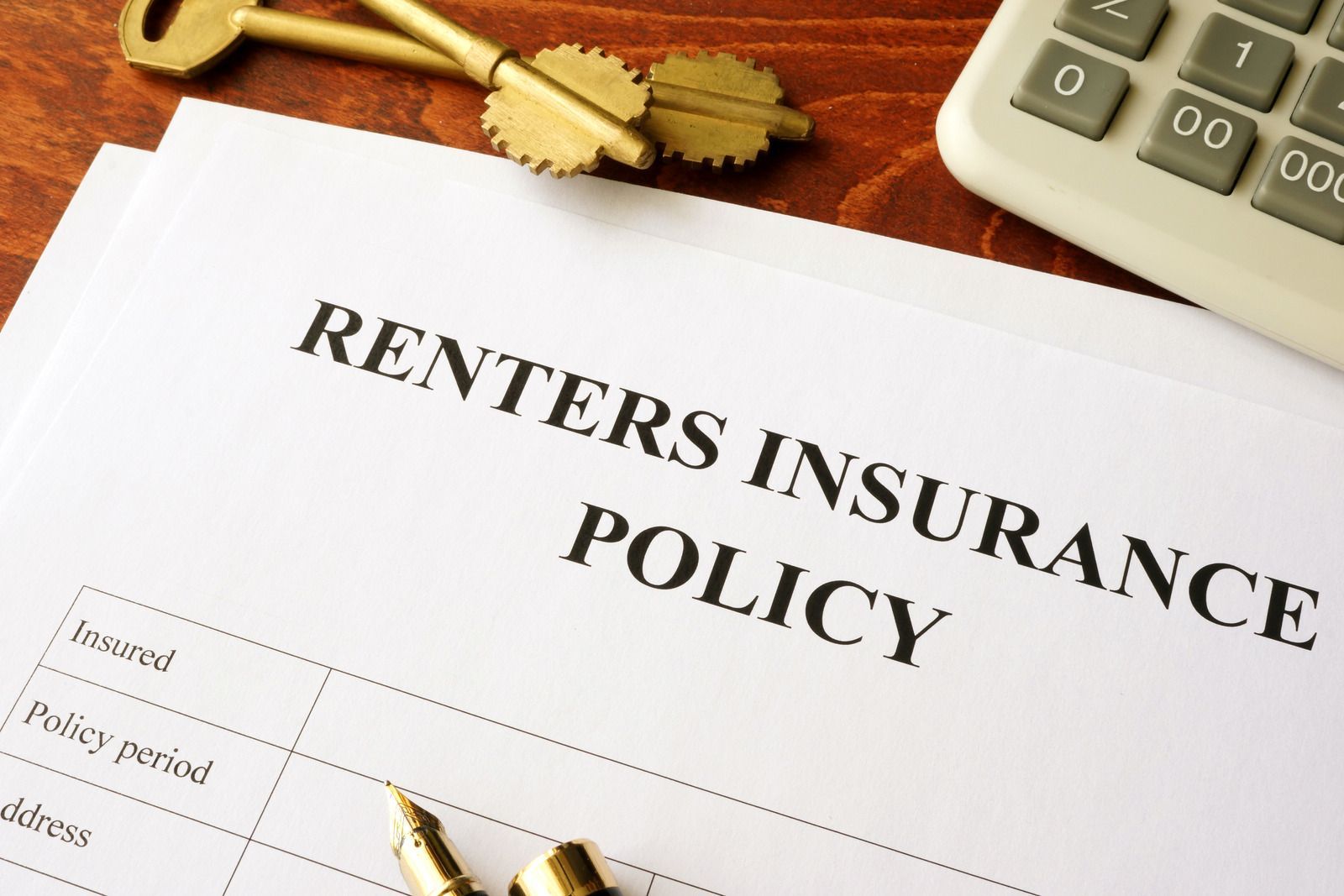 A calculator is sitting on top of a renter 's insurance policy