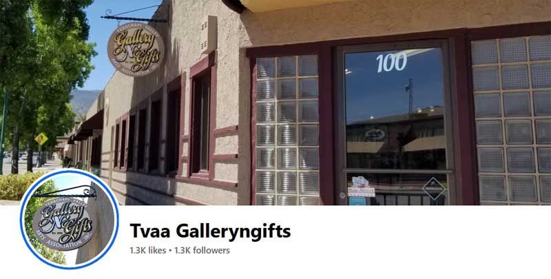 Storefront for Tvaa Gallerygifts with brick facade, large windows, and circular logo sign