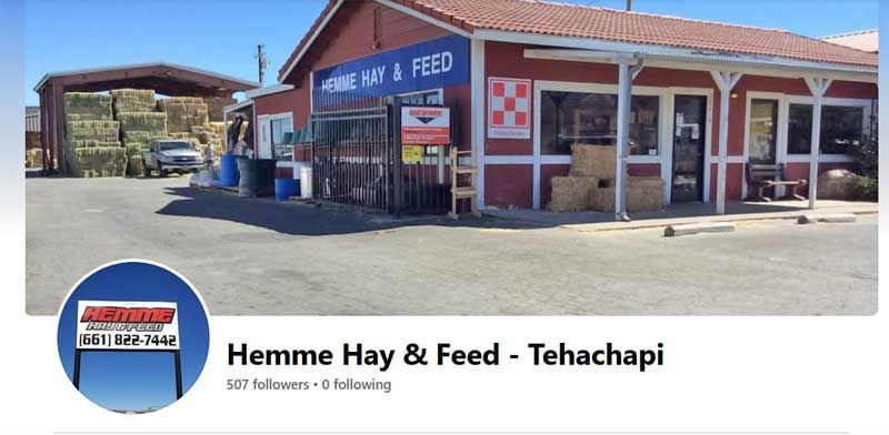 Hemme Hay & Feed storefront in Tehachapi with blue awning and parked tractor-trailer outside