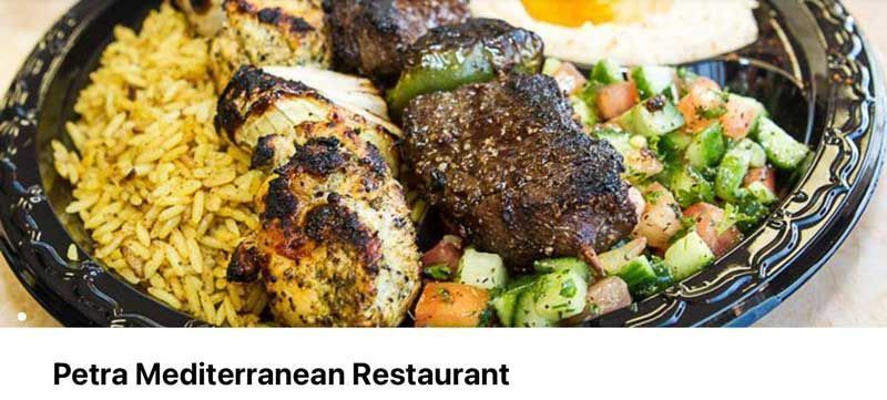 Plated grilled chicken, rice, and salad at Petra Mediterranean Restaurant