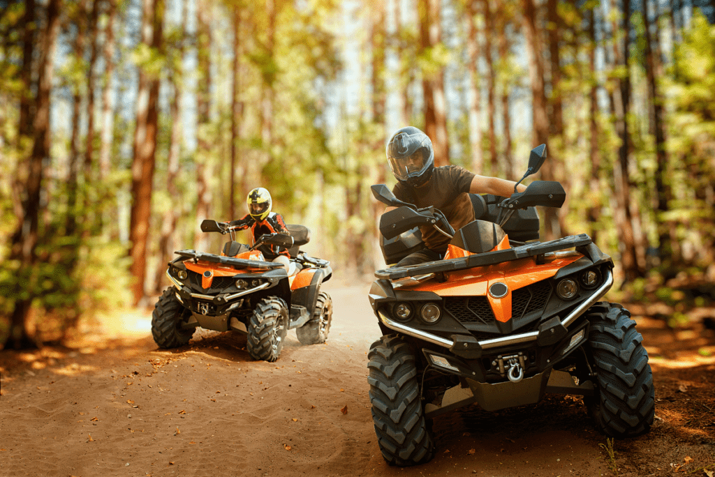 ATV drives down a beautiful road with offroad insurance