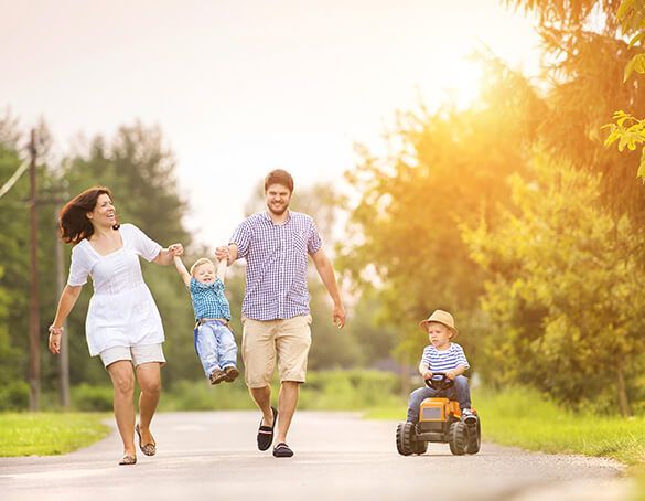 family smiles on a walk knowing they are protected with life insurance 