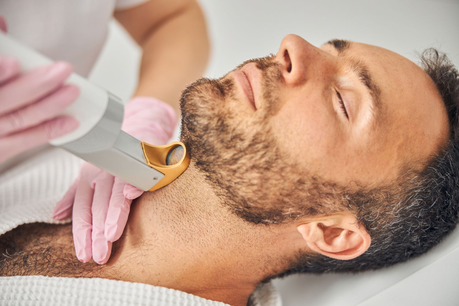 a man is getting a laser hair removal treatment on his neck
