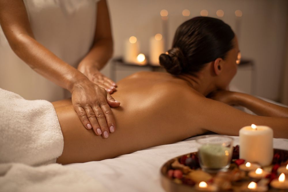 a woman is giving a leg massage to a man