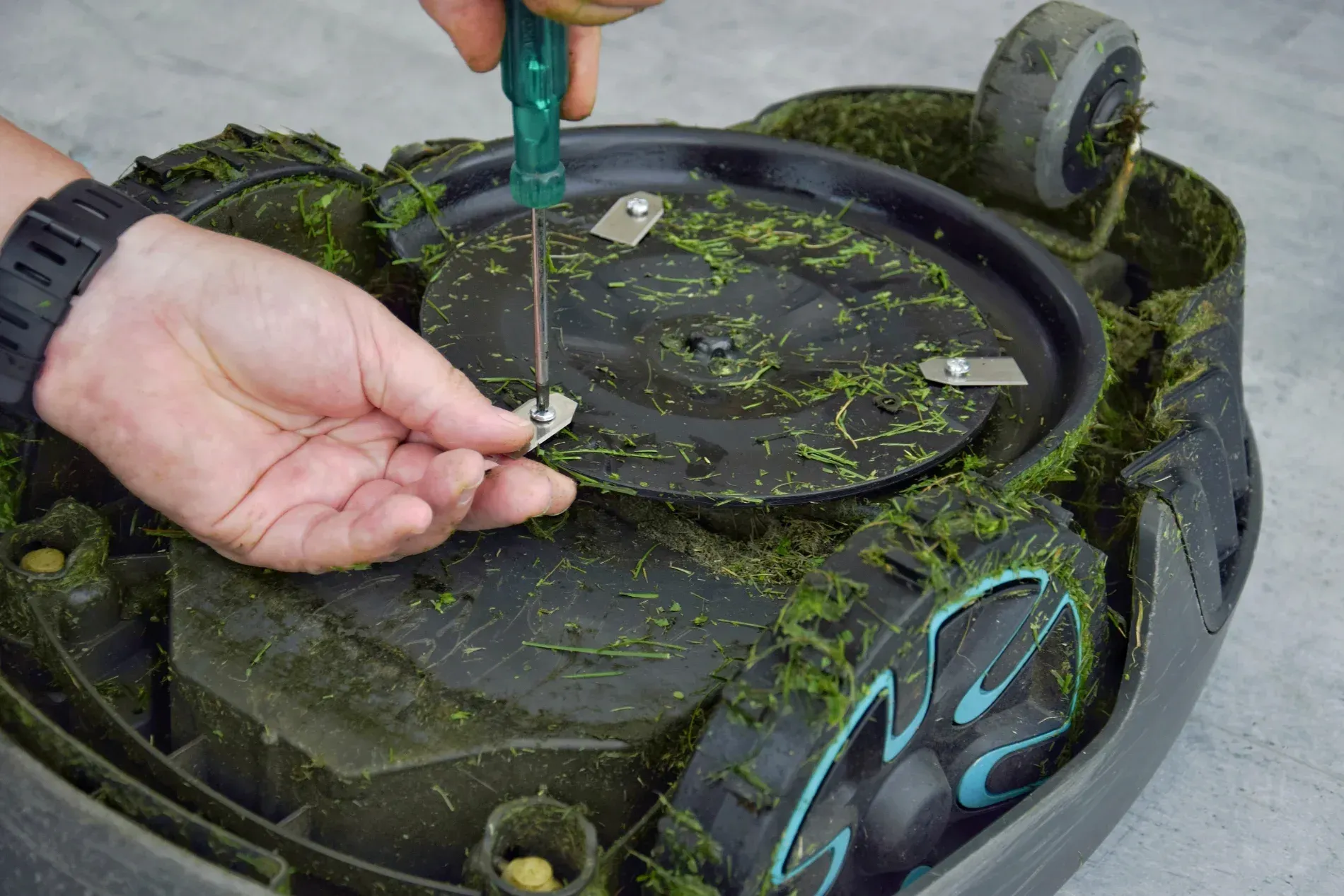 Person Working On A Lawnmower Engine With A Screwdriver — Jack Too You Mobile Servicing and Repairs In Sunshine Coast, QLD