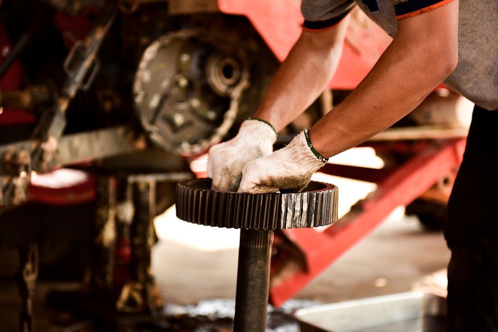 Mechanic In Gloves Working On Machinery Gear — Jack Too You Mobile Servicing and Repairs In Yandina, QLD