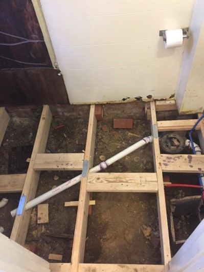 A Wooden Floor Is Being Built In A Bathroom — Philadelphia, PA — Edward Hughes & Son