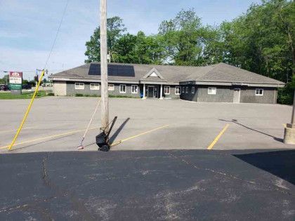 A large building with a parking lot in front of it.