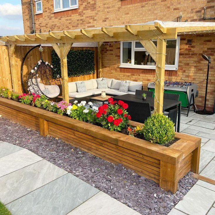 Backyard patio with a stamped concrete patio, wooden fence and a pergola.