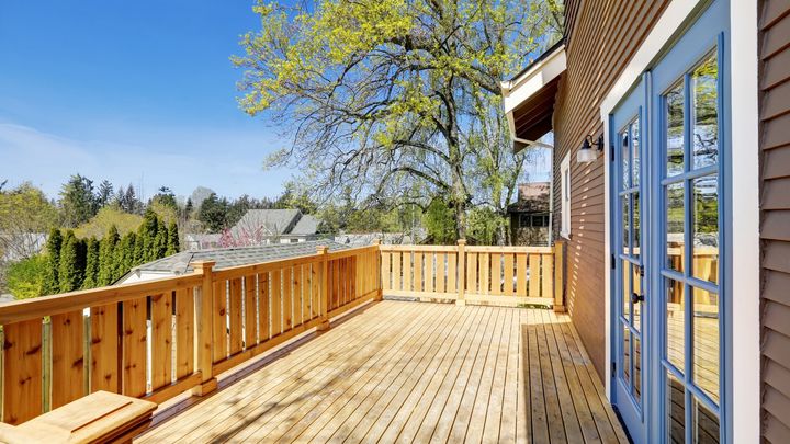 Wooden deck on the upper level of a house.
