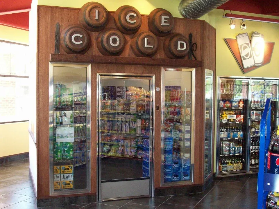 Cooler Door Retrofits: c-store-beer-cave-cooler-with-glass-doors-and-wood-sign