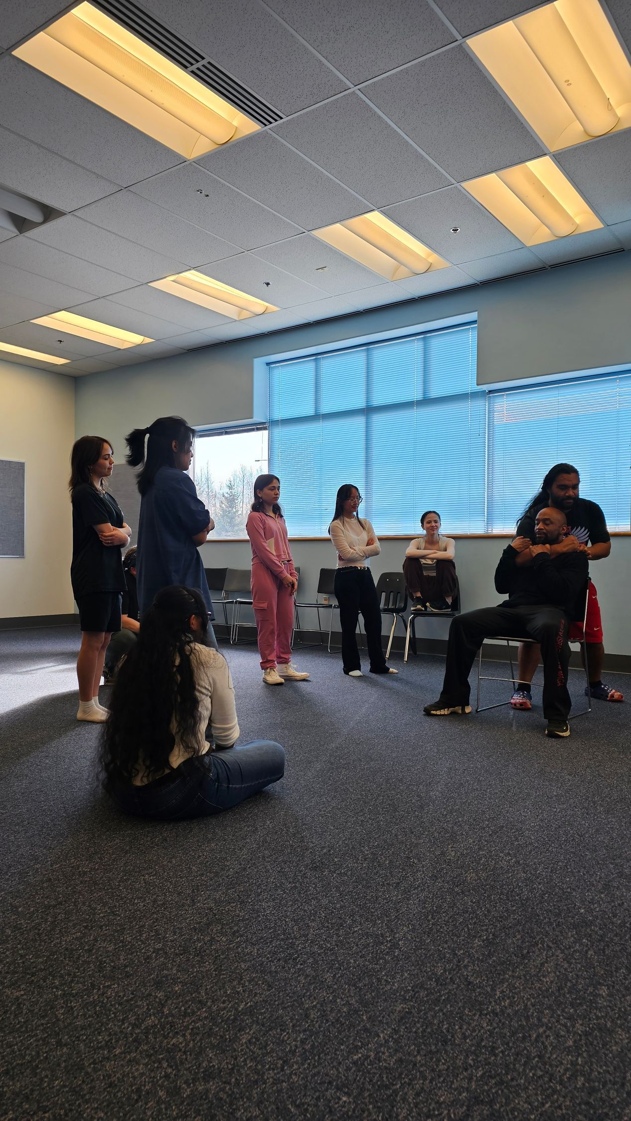 Students watching an instructor teach self defense