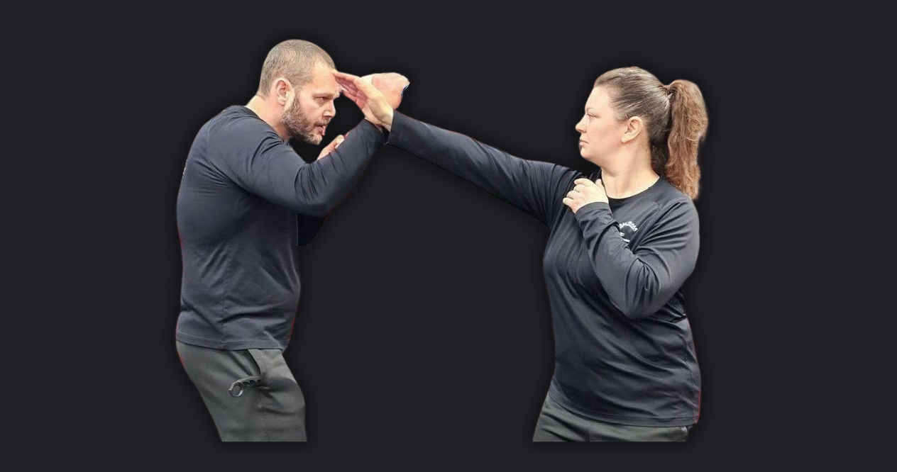 A man and a woman are learning self defense.