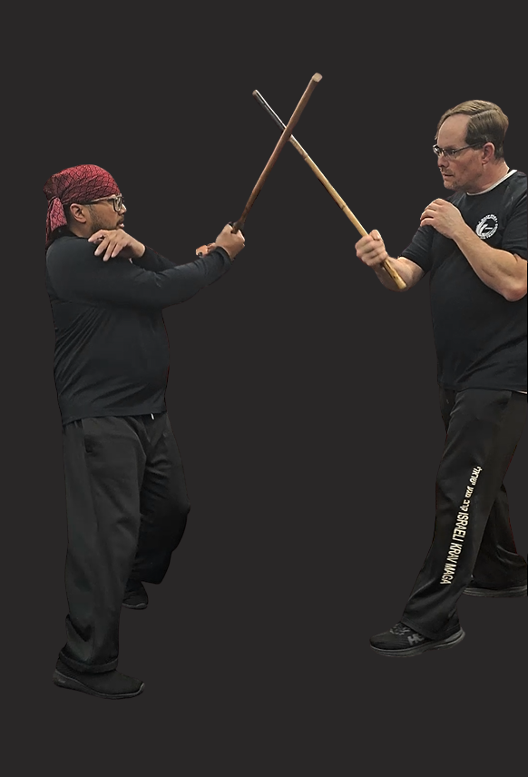 Two men are practicing martial arts in a gym