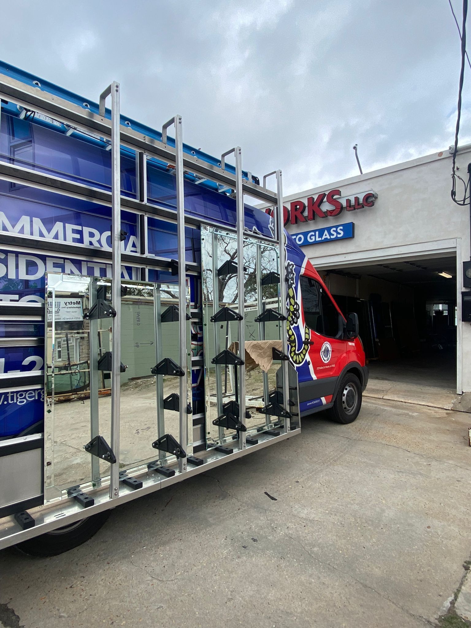A glass delivery truck parked outside a business called