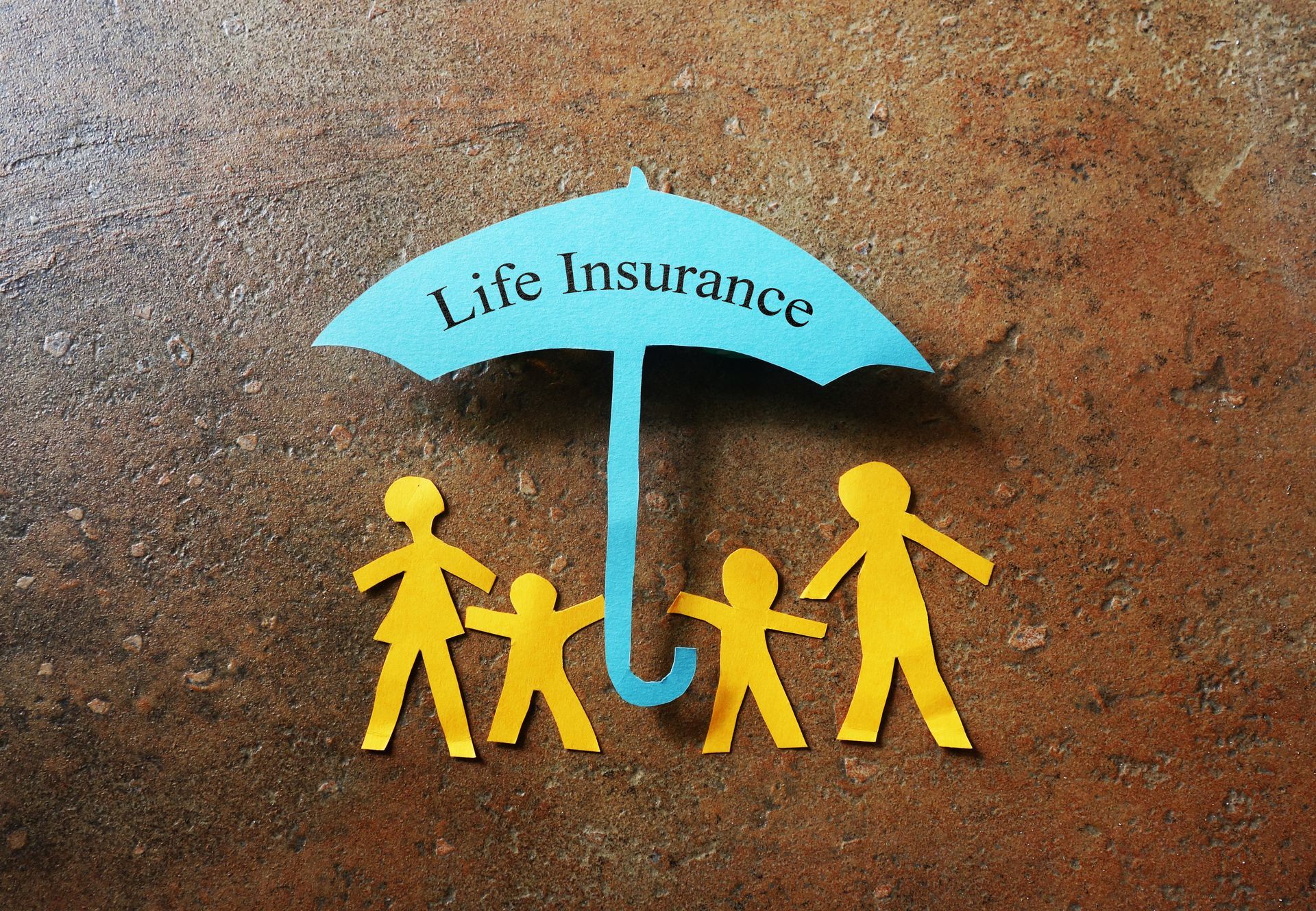 Paper cutouts of a family under an umbrella labeled