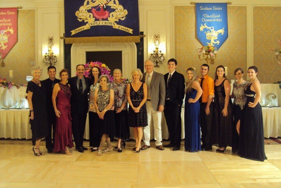 A group of people posing for a picture in front of a banner that says london