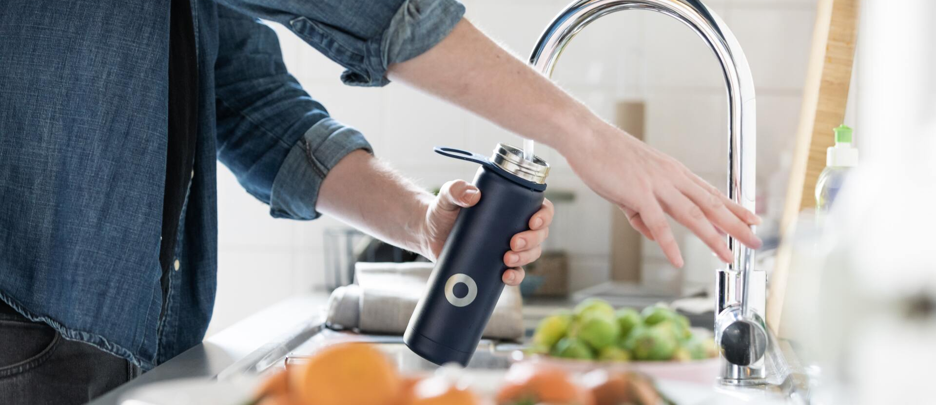 woman filling water bottle
