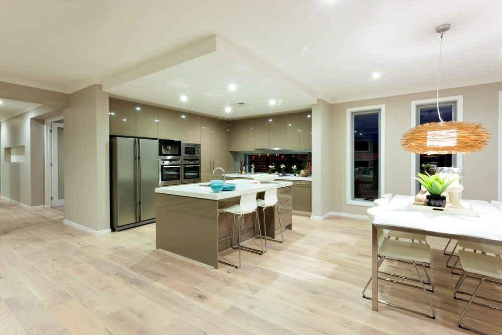 A Kitchen Dining Room in A House with Hardwood Floors and Stainless Steel Appliances — Gateway Manufacturing in Gosford, NSW