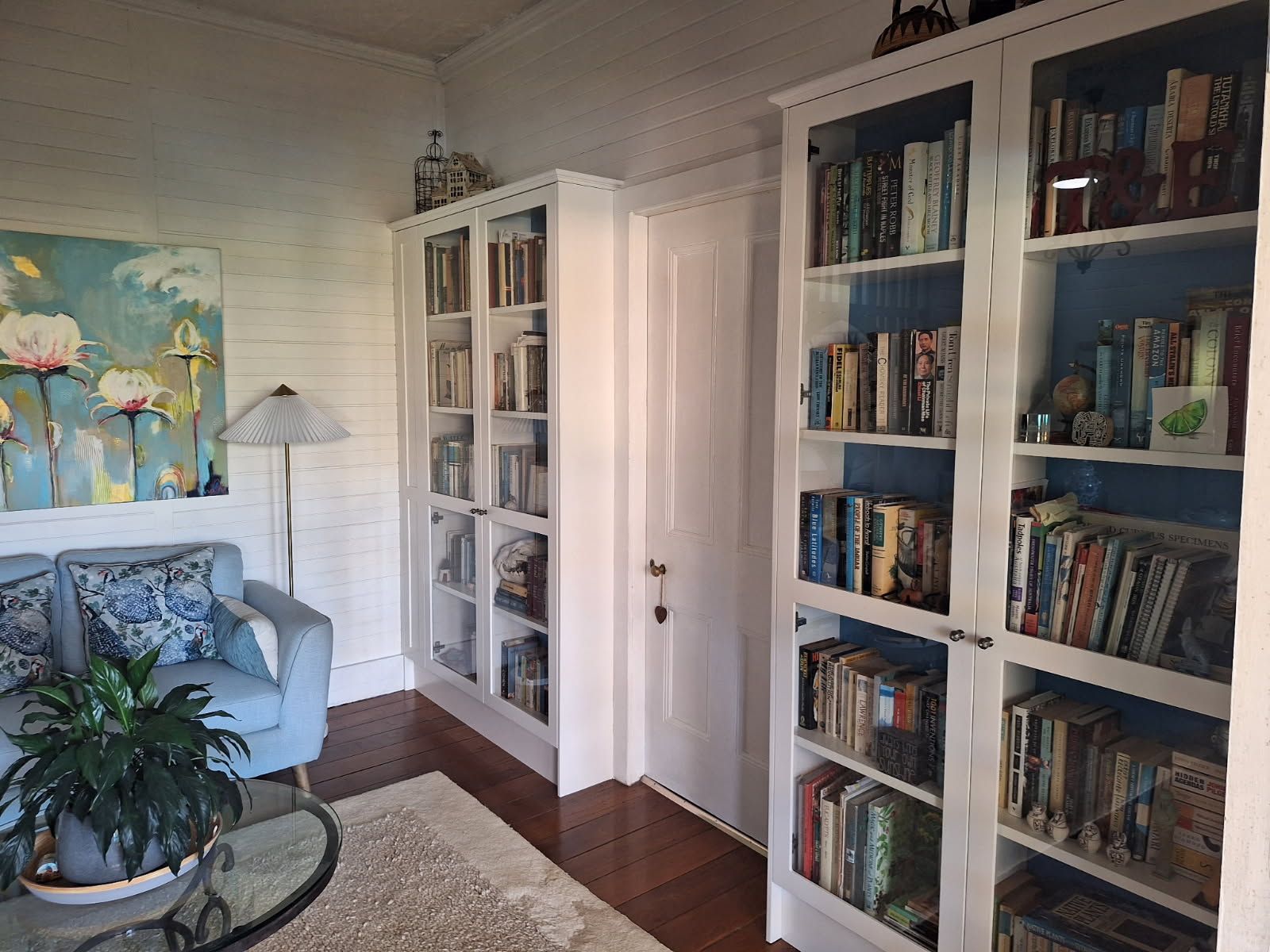 Living Room With Bookshelves, a Blue Couch, and Artwork — Gateway Manufacturing in Morisset, NSW