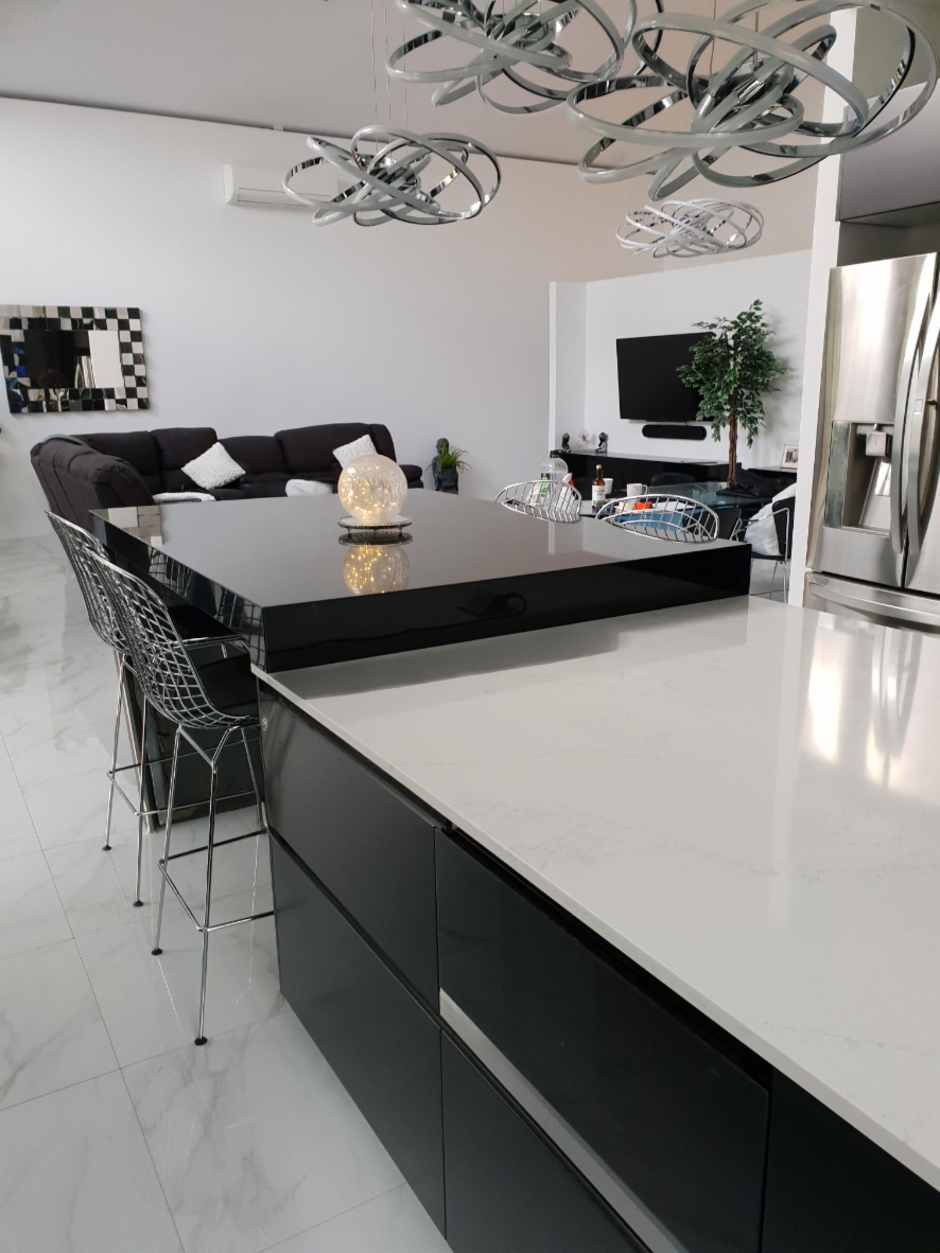 Modern Kitchen With Black and White Island, Dark Cabinets, and a Living Area — Gateway Manufacturing in Newcastle, NSW