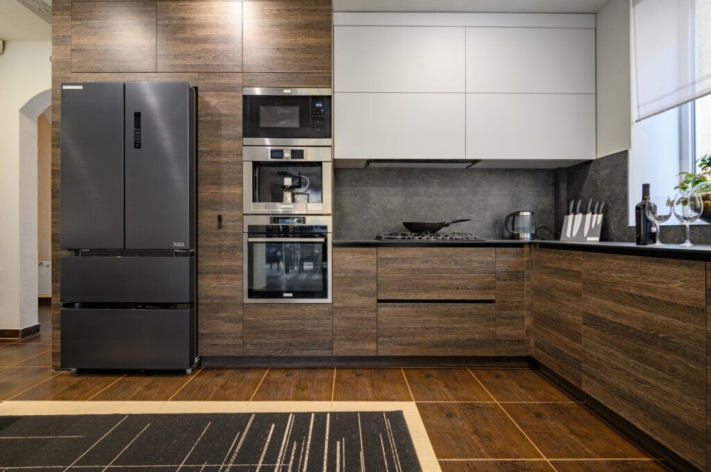 A Kitchen with Stainless Steel Appliances and Wooden Cabinets — Gateway Manufacturing in Wyong, NSW