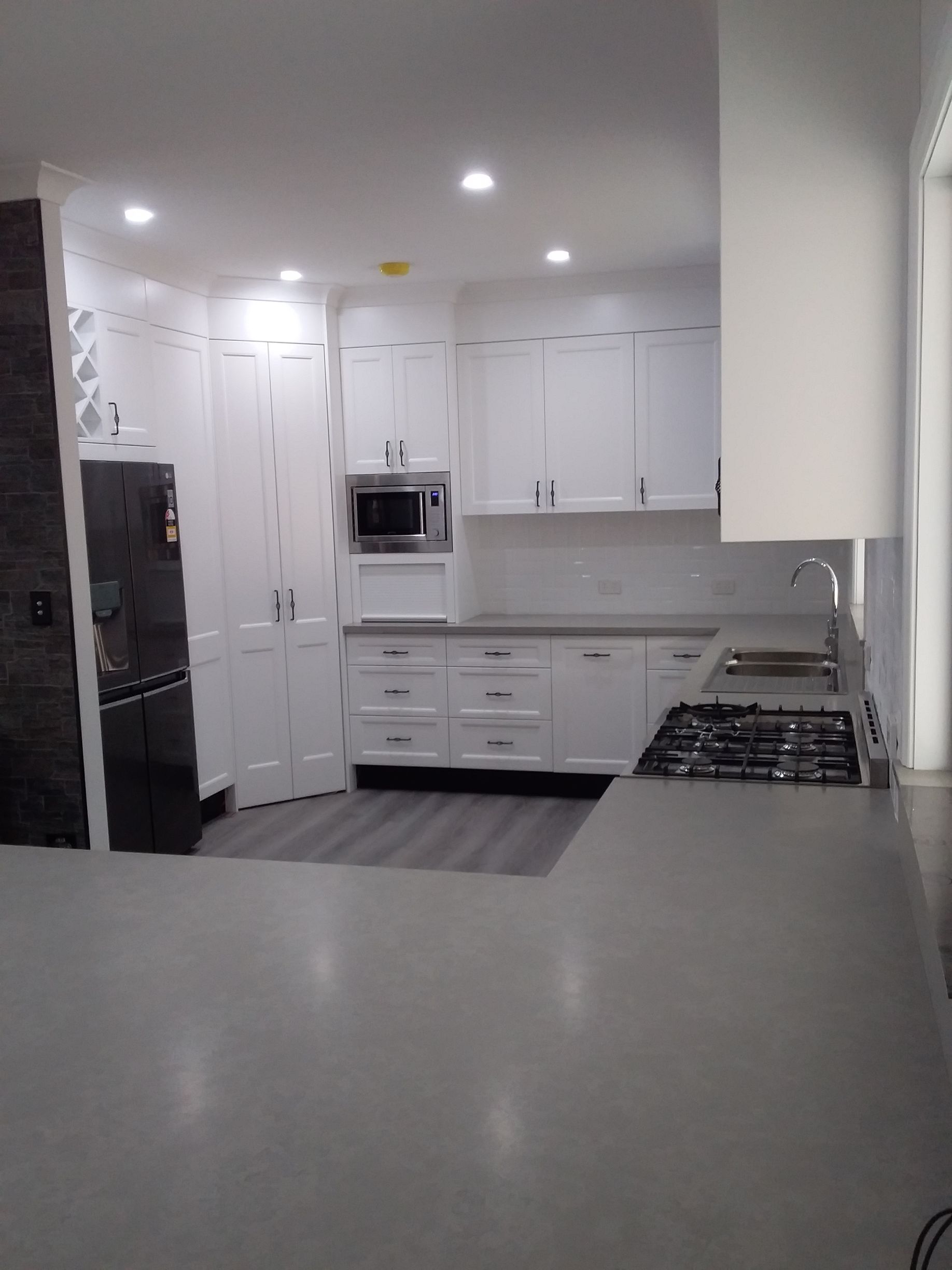 White Kitchen With Gray Countertops, Cabinets, Appliances, and Flooring — Gateway Manufacturing in Gosford, NSW