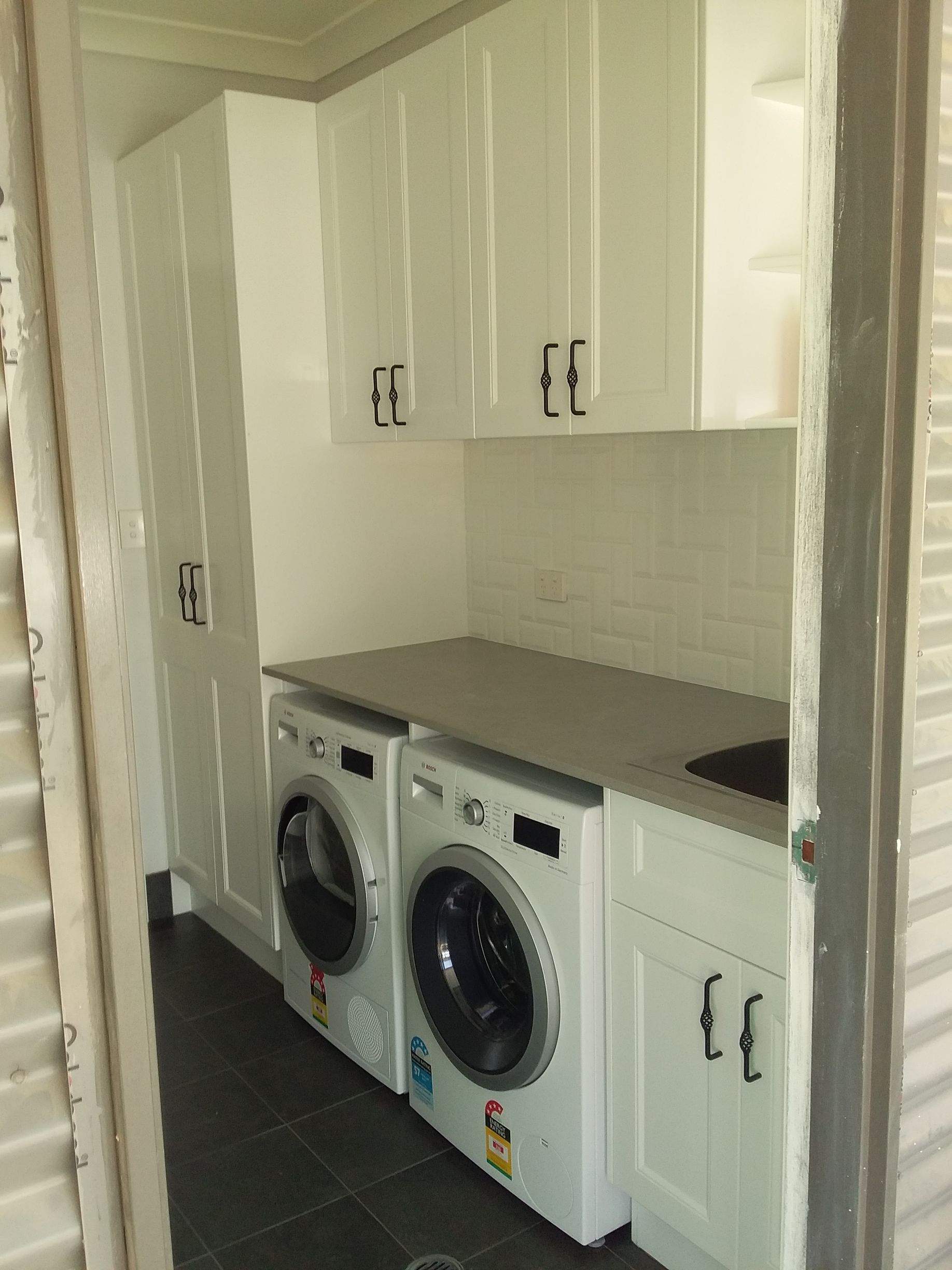 Laundry Room With White Cabinets, Two Washing Machines, and Gray Countertop — Gateway Manufacturing in Morisset, NSW