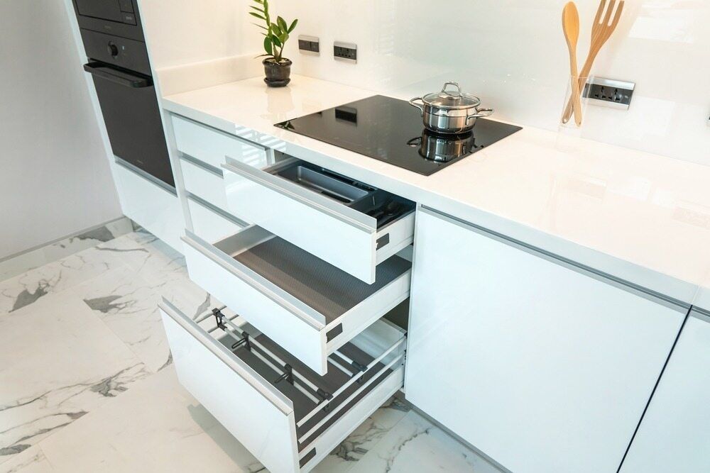 A Kitchen with A Stove Top Oven and Drawers Open — Gateway Manufacturing in Wyong, NSW