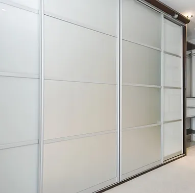 Sliding Closet Doors With Frosted Glass Panels in a Modern Bedroom — Gateway Manufacturing in Morisset, NSW