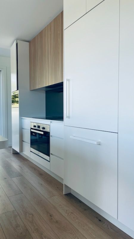 Modern Kitchen With White Cabinetry, Wood Accents, and a Built-in Oven — Gateway Manufacturing in Maitland, NSW