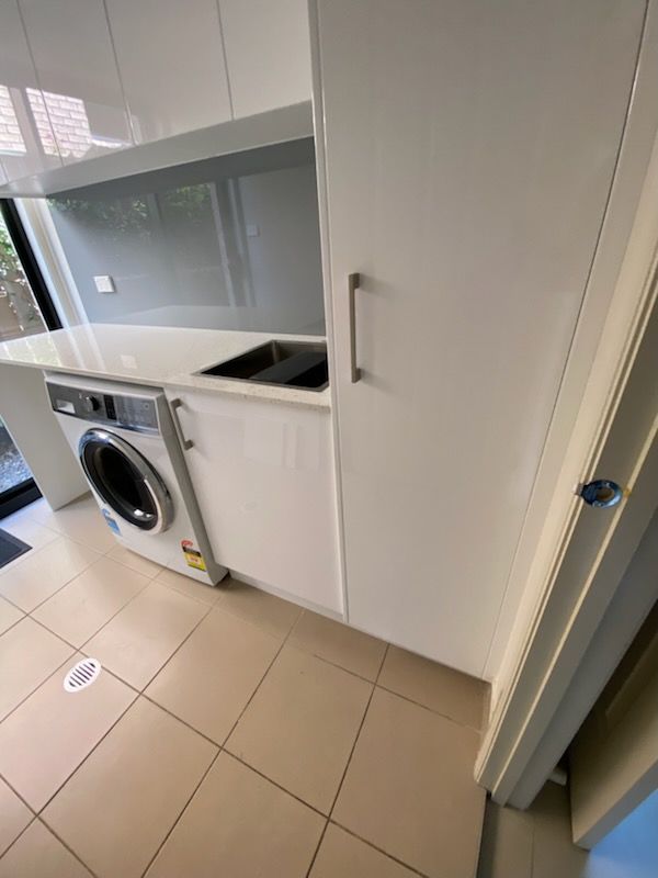 Laundry Room With White Cabinets, a Washing Machine, and a Sink — Gateway Manufacturing in Cessnock, NSW