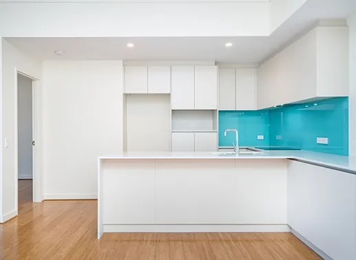 A Kitchen with Wooden Cabinets and A Tiled Floor — Gateway Manufacturing in Cessnock, NSW