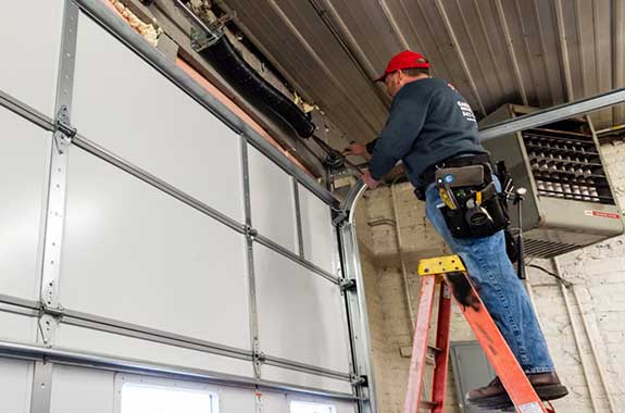 Worker Installing New Garage Door — Antioch, IL — Duke of Doors Worker Installing New Garage Door — Antioch, IL — Duke of Doors