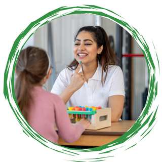 Therapist smiling during a counseling session with a child holding a toy activity box