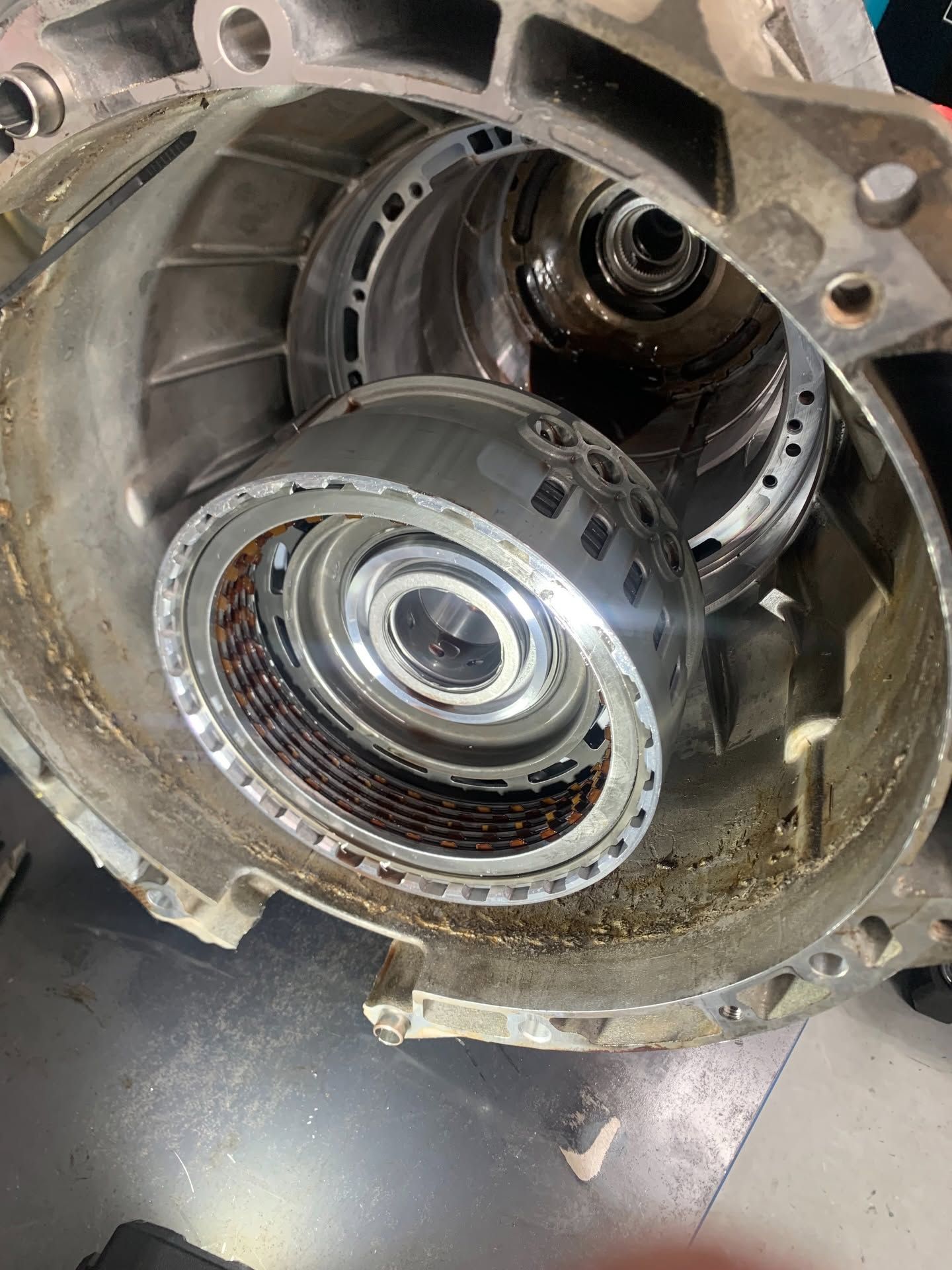 Close-up of a metal mechanical housing with gears and bearings inside, viewed from above.