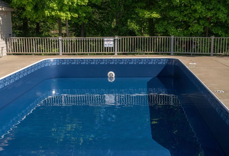 In ground swimming poolwith new vinyl liner being refilled with water ready for use