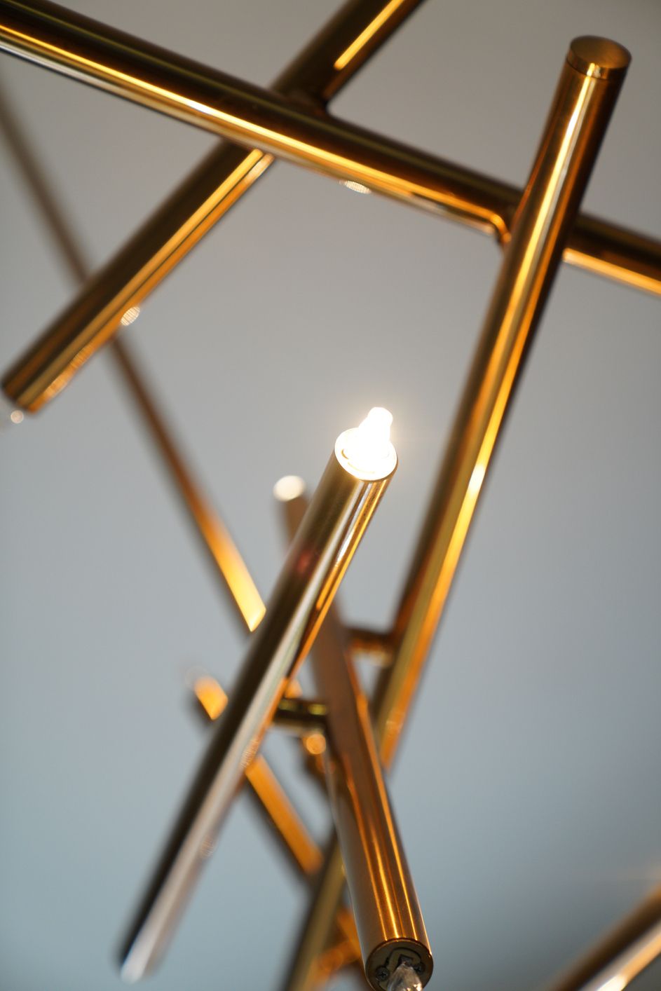 Un primo piano di un lampadario in ottone con una luce accesa