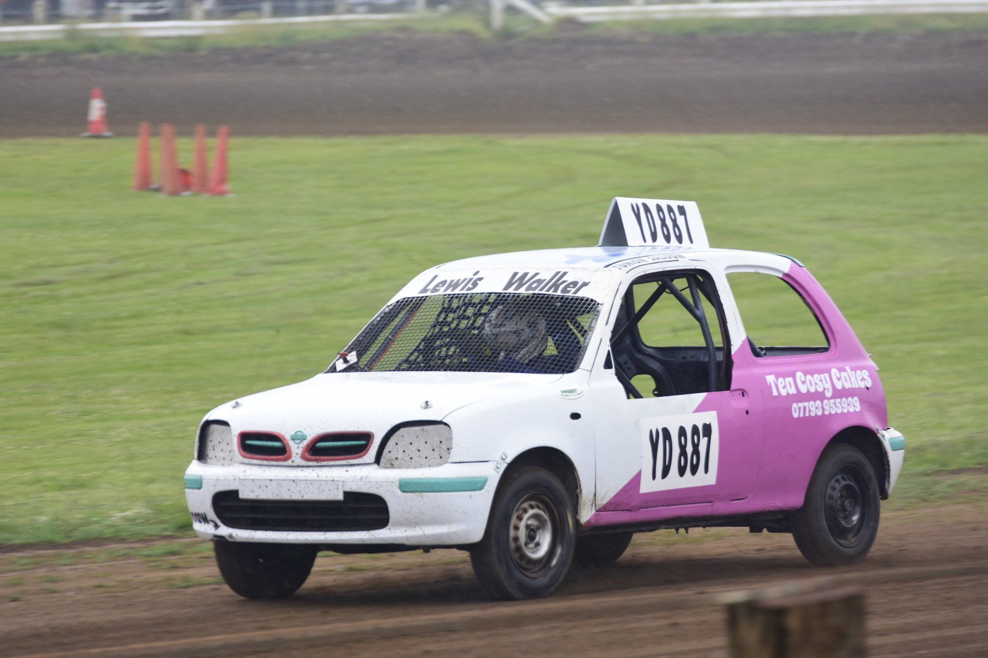 A white and purple race car with the number y1337 on the side
